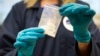 FILE - A bag of 4-fluoro isobutyryl fentanyl, seized in a drug raid, is displayed at the U.S. Drug Enforcement Administration laboratory in Sterling, Virginia, Aug. 9, 2016. The U.S. is looking to reengage with China to stop the flow of illicit synthetic drugs into the U.S.