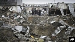 Afghan security members of Contrack company stand at the scene of a car bomb explosion in Kabul, Afghanistan, December 17, 2012. 