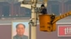 A man works on a security camera that was installed at Tiananmen Square in Beijing, November 1, 2013. 