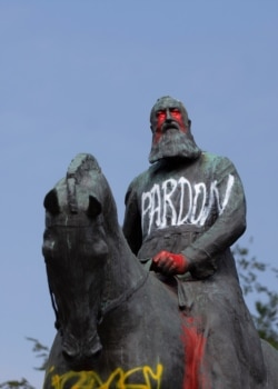 A statue of Belgium's King Leopold II is smeared with red paint and graffiti in Brussels, June 10, 2020. In the wake of George Floyd's death King Leopold II is now increasingly seen as a stain on the nation.