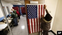 Election workers set up voting booths at Memorial Elementary School in Little Ferry, N.J., Nov. 6, 2012.