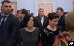 Members of Jehovah's Witnesses react in a court room after a judge's decision in Moscow, April 20, 2017. Russia's Supreme Court has banned the Jehovah's Witnesses from operating in the country.