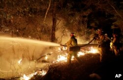 Fire crews battle a wildfire in Santa Rosa, California, Oct. 14, 2017.