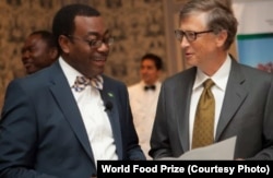 African Development Bank President Akinwumi Adesina, recipient of the 2017 World Food Prize, speaks with U.S. philanthropist Bill Gates.