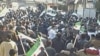 Demonstrators protest against Syria's President Bashar al-Assad after Friday prayers, with banners that read, 'Yes to support the Free Army,' in Al Qusour, Homs, Syria, March 2, 2012.
