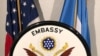 A U.S. Embassy seal is displayed in front of U.S. and Somali flags. (Source - Twitter @US2SOMALIA)