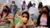 Faithful wearing face masks and maintain social distancing as a precaution against the coronavirus attend a Christmas Mass in Ahmedabad, India, Dec. 25, 2020. 