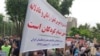Dozens of retired and active Iranian teachers demonstrate outside Tehran's planning & budget office, May 10, 2018, to demand greater government funding for education. In this image provided to VOA Persian by an audience member, protesters hold a sign advocating free education for Iranian children. Iranian security forces later broke up the protest, beating and arresting several people.