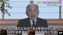 Un écran affiche l’empereur Akihito livrant son discours à Tokyo, le 8 août 2016. Dans une adresse rare au public, il signale lundi son désir apparent d'abdiquer en exprimant son inquiétude au sujet de sa capacité à exercer pleinement ses fonctions. 