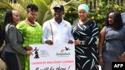Uganda's Minister for Tourism Godfrey Kiwanda (C) poses next to participants during the launch of the Miss Curvy beauty contest in capital Kampala, Feb. 5, 2019.