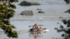 FILE - A Chinese boat with a team of geologists surveys the Mekong River, at the border between Laos and Thailand, April 23, 2017. 