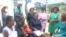 Mothers at Marondera Hospital talk to U.S. officials about HIV and AIDS on Dec. 10, 2024, in Marondera, Zimbabwe.