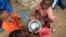 Internally displaced Somali children eat breakfast at Sayyidka camp in the Howlwadag district, south of Somalia's capital Mogadishu, May 3, 2013. 