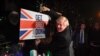 FILE - Britain's Prime Minister and Conservative party leader Boris Johnson poses with a sledgehammer, after hammering a "Get Brexit Done" sign into the yard of a supporter, in South Benfleet, Britain, Dec. 11, 2019.