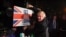 FILE - Britain's Prime Minister and Conservative party leader Boris Johnson poses with a sledgehammer, after hammering a "Get Brexit Done" sign into the yard of a supporter, in South Benfleet, Britain, Dec. 11, 2019.