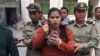 Ms. Tep Vanny, Beung Kok land rights activist, is escorted by police officers at the Appeal Court in Phnom Penh, on Thursday, November 17, 2016. (Kann Vicheika/VOA Khmer)