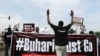 Protesters carry placards and banners during a Democracy Day rally in Abuja, Nigeria, June 12, 2021. 