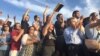 Supporters cheer as Democratic presidential candidate Bernie Sanders speaks outside R.F.K. Stadium, in southeast Washington, June 9, 2016.