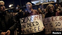 FILE - Members of the communist-affiliated PAME trade union take part in a demonstration outside a hotel, where members of the Greek government meet with representatives of the country's international lenders, in Athens, Greece, March 1, 2017.