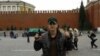 A man identified as Tajik Alan Chekranov holding a pistol and extending one finger -- a common sign used by Islamist militants to mean "one," an attestation of belief in tawhid, or monotheism -- at Red Square in Moscow, possibly in 2012.