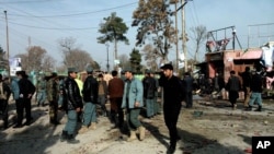 Kepolisian Afghanistan dan warga sipil memeriksa lokasi serangan bom bunuh diri di Maymana, ibukota provinsi Faryab, Afghanistan (18/3). Seorang pembom bunuh diri dengan mengendarai kendaraan semacam becak, meledakkan dirinya di sebuah pasar menjelang pelaksanaan pemilu presiden negara itu. Sedikitnya 15 orang dilaporkan tewas dalam insiden tersebut.