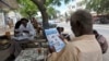 FILE - People read newspapers in the streets of Somalia's capital Mogadishu May 3, 2011. Popular Somali newspaper Xog-Ogaal remains closed and its editor in detention for a second day.