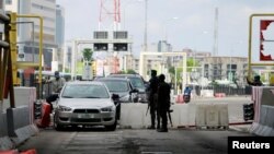 FILE - Cars drive through the Lekki toll gate, a site where soldiers had opened fire on protesters late on Tuesday, as Nigeria's Lagos state eases a round-the-clock curfew imposed in response to protests against alleged police brutality, Oct. 24, 2020. 