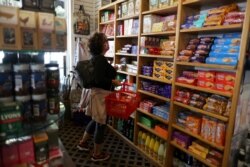 FILE - Paula Jarvis, 61, shops at the King's Head pub in Santa Monica, Calif., May 6, 2021. The U.S. financial press on May 19 was full of comparisons of the current economic climate to that of the late 1960s, which preceded an era of inflation.