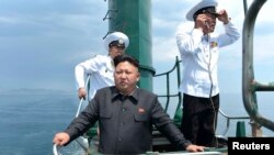 朝鲜官方媒体2014年6月公布的照片显示领导人金正恩视察一艘老旧潜艇。美国研究人员说，卫星图像分析显示，朝鲜可能已获得一艘新潜艇。
