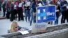 Kara Bonham, at left, registers to vote for the Democratic caucus at the University of Nevada, Feb. 20, 2016, in Reno, Nev.