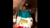 This photo released by by Mexico's Foreign Minister Marcelo Ebrard shows Bolivia's former President Evo Morales holding a Mexican flag aboard a Mexican Air Force aircraft, Nov. 11, 2019. 