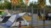 FILE - A 1-year-old Cuban asylum-seeker is seen in a makeshift migrant camp near the Gateway International Bridge in Matamoros, Tamaulipas, Mexico, June 29, 2019.