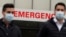 FILE - People walk past a hospital emergency entrance sign during the coronavirus pandemic in the Manhattan borough of New York City, Dec. 4, 2020. 