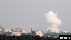 FILE - Smoke rises after an air strike in Saraqeb in Idlib province, Syria, Feb. 28, 2020. 