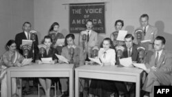 A group shot of VOA broadcasters. VOA used to be part of the "U.S. Information Agency."