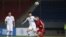 A handout photo taken Oct. 15, 2019, by the Korea Football Association (KFA) shows players fighting for the ball during a World Cup 2022 qualifying match between South Korea and North Korea at Kim Il Sung Stadium in Pyongyang.