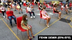 Elementary school students wearing face masks keep their distance on the first day of school in Sarajevo, Bosnia and Herzegovina, 01 September 2020.