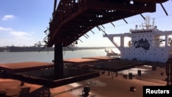 FILE - A bulk carrier is loaded with iron ore at Port Hedland, Western Australia. Forecasters said Feb. 14, 2025, that Cyclone Zeila was moving south toward Port Hedland, with landfall expected in the afternoon. 