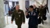 FILE - U.S. Marine Corps Gen. Kenneth McKenzie, left, head of U.S. Central Command, walks to a House Armed Services Committee hearing on Capitol Hill, March 10, 2020, in Washington. McKenzie spoke with senators March 12.