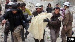 Des Casques blancs retirent une victime des décombres d'un bâtiment détruit suite à une attaque aérienne à Idlib, Syrie, 15 mars 2017