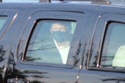 President Donald Trump drives past supporters gathered outside Walter Reed National Military Medical Center in Bethesda, Maryland, Oct. 4, 2020.
