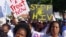 FILE - Activists march in Durban, South Africa, July 18, 2016, at the start of the 21st World Aids Conference. A new clinical trial is underway in South Africa on an experimental vaccine that could safely prevent HIV, the virus that causes AIDS.