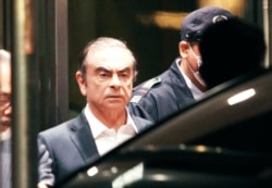 FILE - Former Nissan Chairman Carlos Ghosn leaves the Tokyo Detention Center in Tokyo, April 25, 2019.