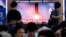 People watch a TV showing a file image of North Korea's missile launch during a news program at the Seoul Railway Station in Seoul, South Korea, July 31, 2019. 