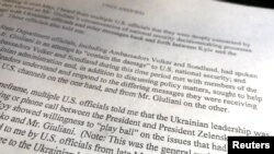 FILE - A section of the report from the U.S. intelligence community whistleblower to the U.S. House Intelligence Committee is seen after being released by the committee in Washington, Sept. 26, 2019.