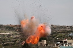 An explosion is seen following Russian airstrikes on the village of al-Bara in the southern part of Syria's northwestern Idlib province, March 5, 2020.