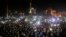 Anti-government protesters light torches and mobile devices during a rally in Independence Square in Kyiv, Ukraine, Feb. 21, 2014.