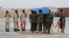 Members of a Somali military unit carry the body of Mogadishu Mayor Abdirahman Omar Osman for burial, in Mogadishu, Somalia, Aug. 4, 2019. Osman was killed in a suicide bombing July 24.