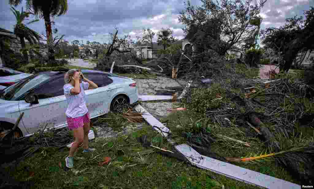 Marie Cook reacts to the damage to her home in the Binks Estates community after a tornado formed by Hurricane Milton touched down in Wellington, Florida, Oct. 9, 2024. 