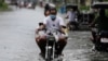 Residents on a motorcycle negotiate a flooded road due to Typhoon Molave in Pampanga province, northern Philippines, Monday, Oct. 26, 2020. A fast-moving typhoon forced thousands of villagers to flee to safety in provinces south of the Philippine…